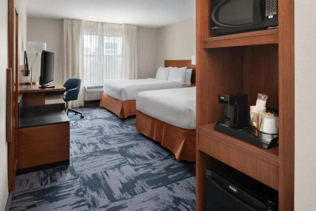 Room with two beds, a microwave, mini-fridge and coffee maker at Fairfield Inn & Suites Kissimmee/Celebration