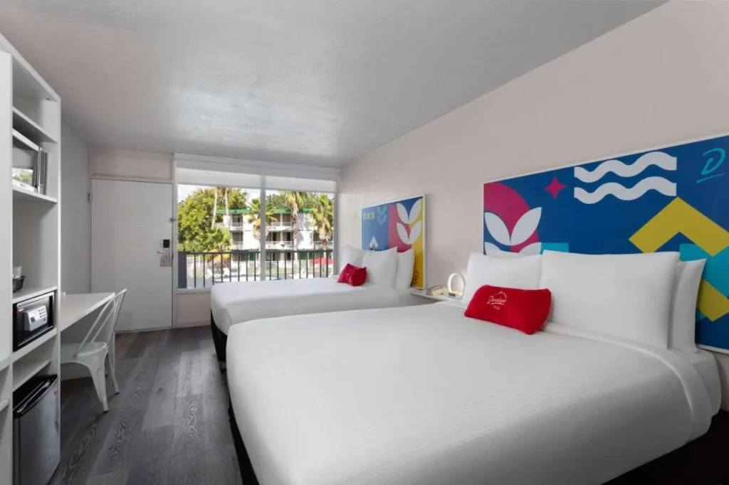 Room with two beds and colorful headboard art at Baymont by Wyndham Lake Buena Vista South