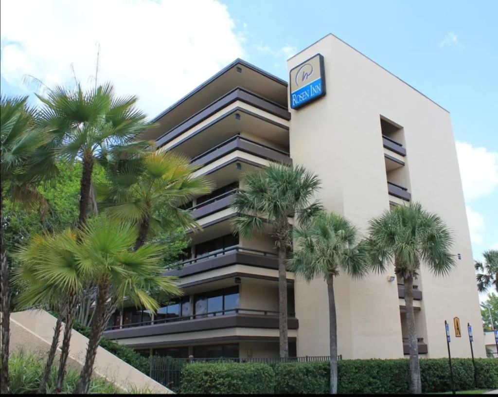 Rosen Inn muestra en la torre de Rosen Inn en Pointe Orlando detrás de altas palmeras