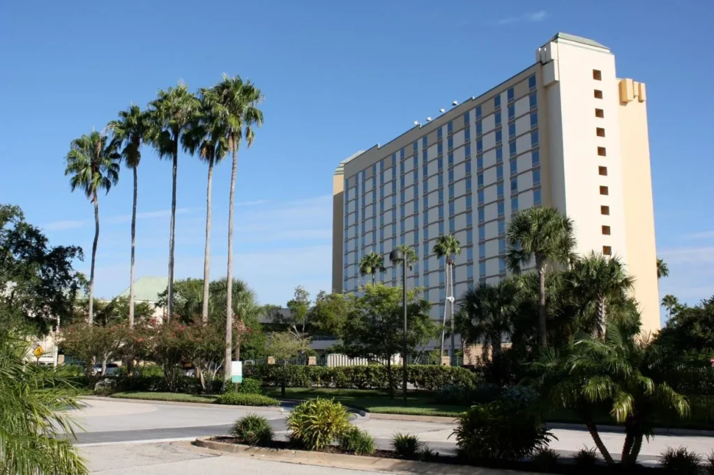 Rosen Plaza Hotel tower behind tall palm trees and the entrance drive on International Drive