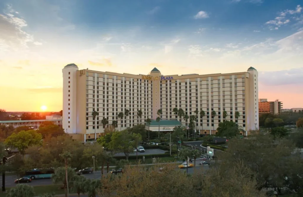 Rosen Plaza Hotel tower, entrance drive and street below at sunset