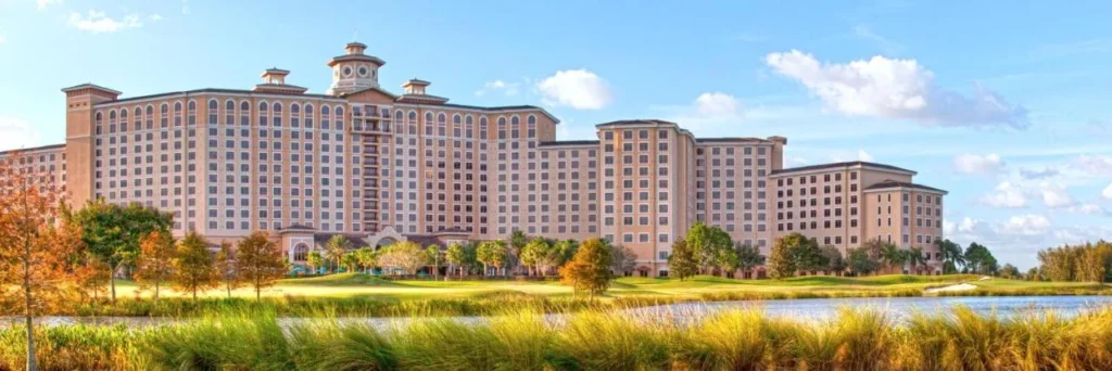 Rosen Shingle Creek hotel building seen across a lake and golf course grasses
