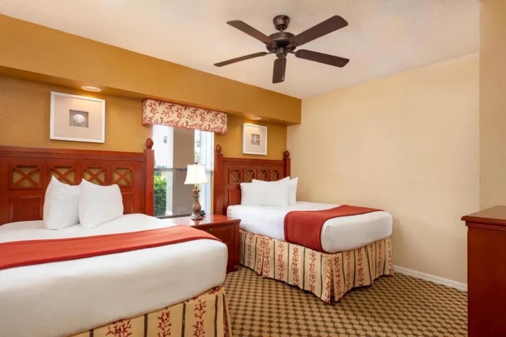 Second bedroom with two double beds and a ceiling fan in a Westgate Lakes two-bedroom villa