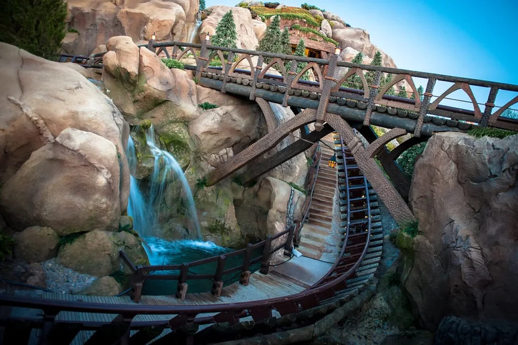 Seven Dwarfs Mine Train track, wooden bridge and waterfall rockwork at Magic Kingdom