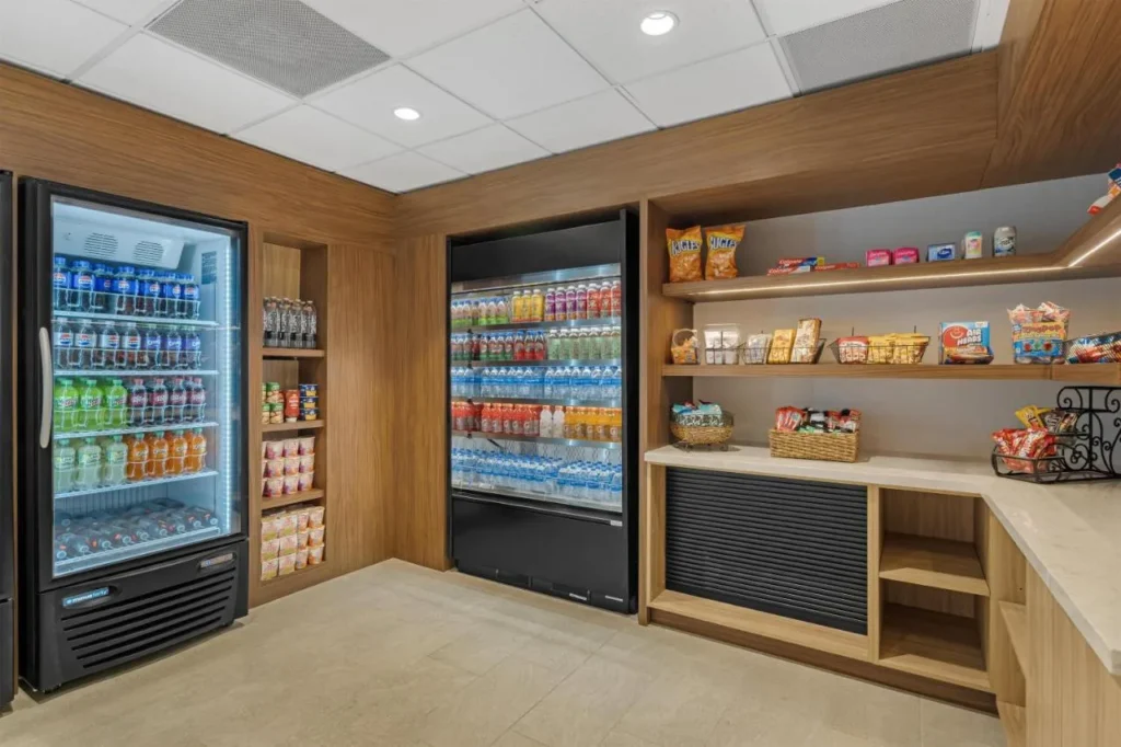 Peque&ntilde;o mercado con refrigeradores de bebidas y estantes para refrigerios en Sonesta ES Suites Lake Buena Vista