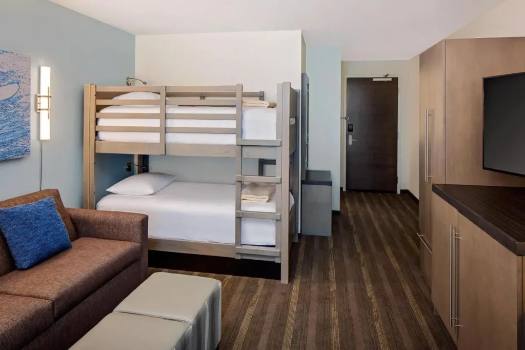 Sofa and bunk beds in a family suite living area at Hyatt House across from Universal