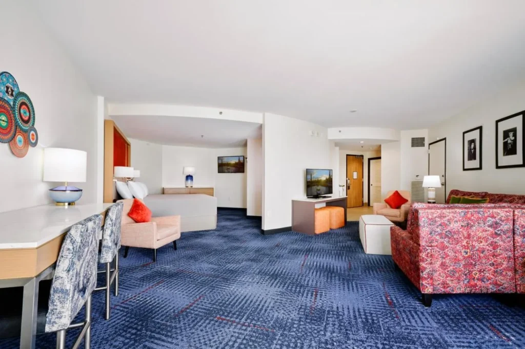 Spacious suite with a bed nook, sofa, desk and two TVs at Hard Rock Hotel Orlando