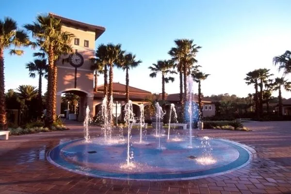 Splash fountain on a brick plaza beneath a clock tower at Orange Lake Resort