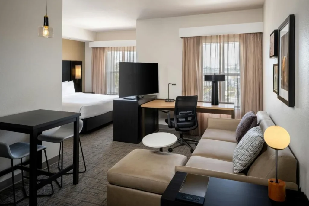 Studio suite with king bed, sofa, work desk and high-top table at Residence Inn Melbourne