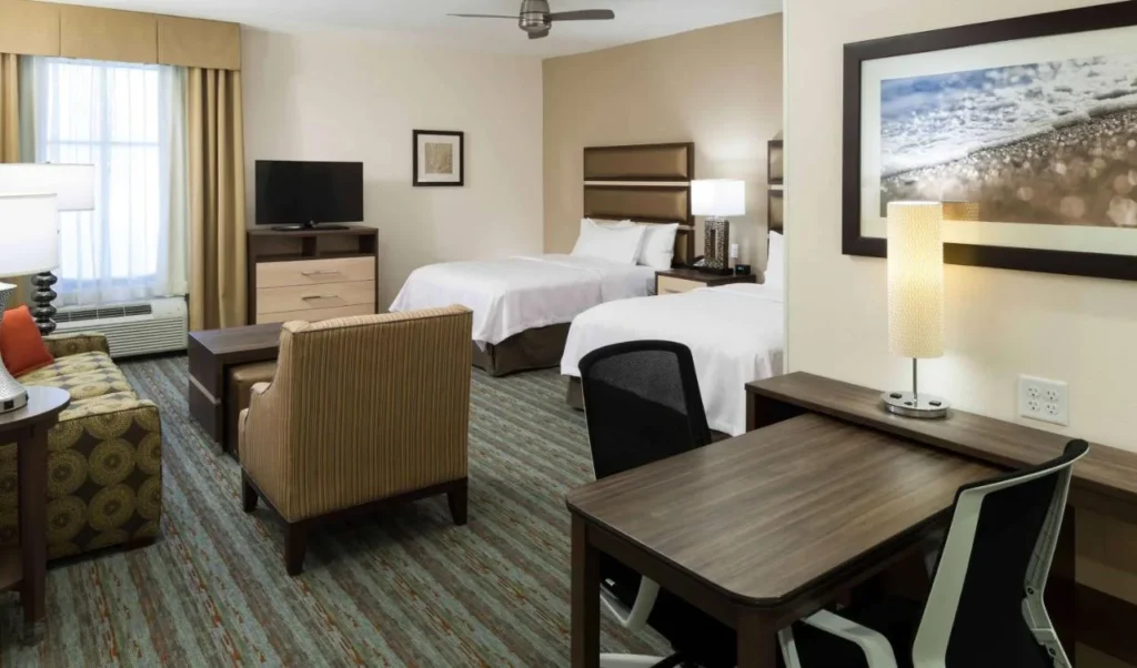 Studio suite with two beds, sofa and desk at Homewood Suites Cape Canaveral-Cocoa Beach