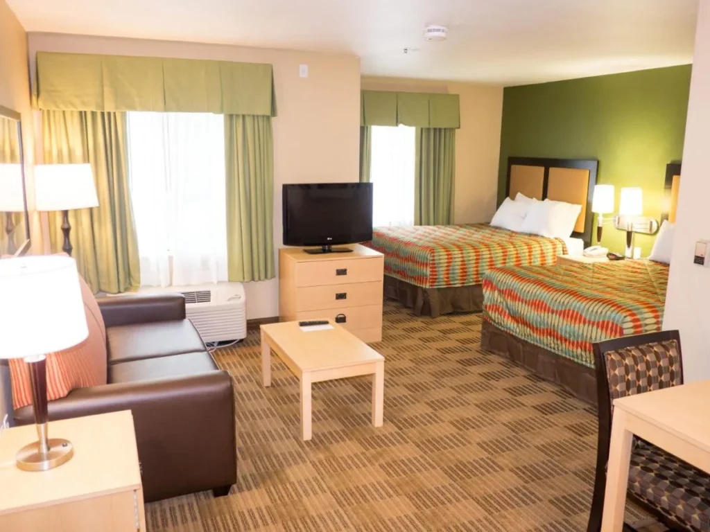Studio suite with two beds, sofa and TV at Extended Stay America Lake Buena Vista
