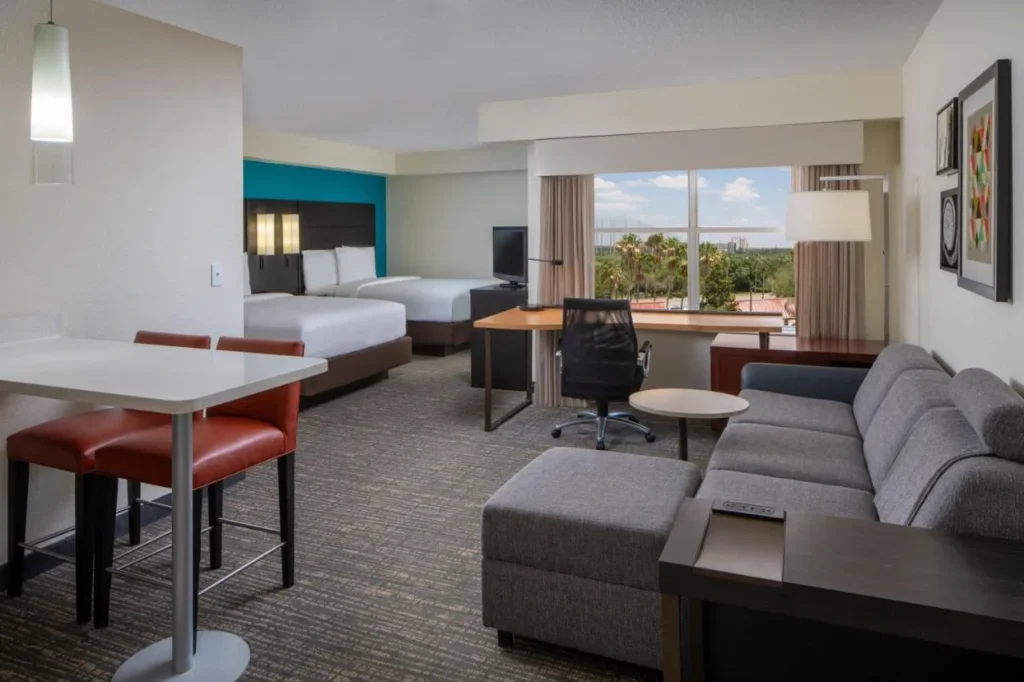 Suite tipo estudio con dos camas, sofá, escritorio y mostrador de comedor en el Residence Inn Orlando Convention Center
