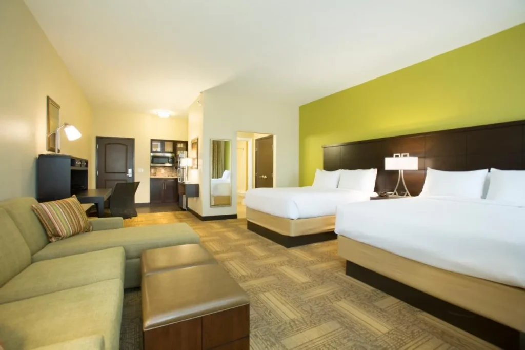 Studio suite with two queen beds, sofa and kitchenette at Staybridge Suites Orlando at SeaWorld