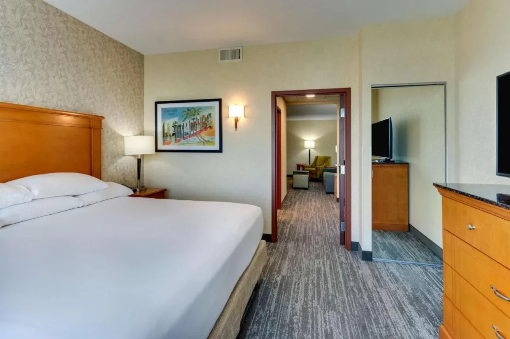 Suite king bedroom with door to the living room at Drury Inn & Suites near Universal