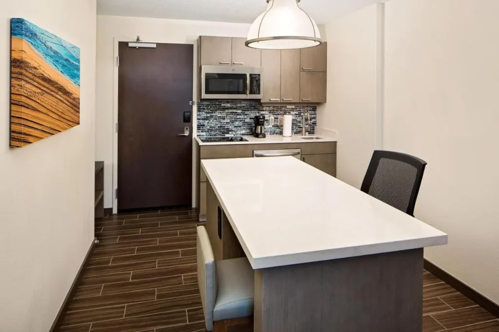 Suite kitchen with island, cooktop, microwave and dishwasher at Hyatt House across from Universal
