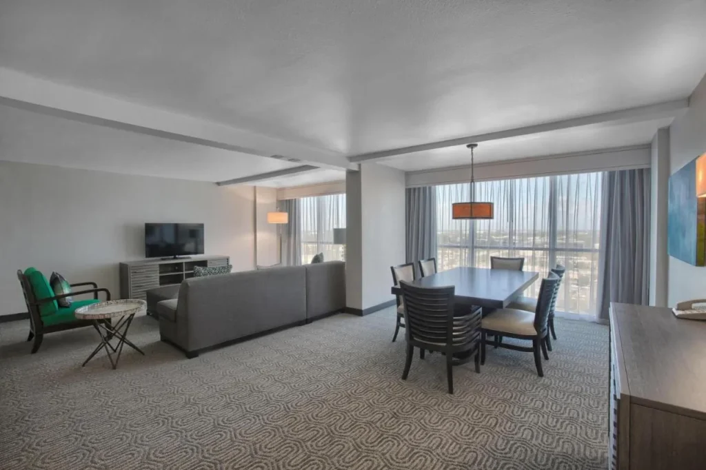Suite living and dining area with sofa and dining table, DoubleTree at the Entrance to Universal