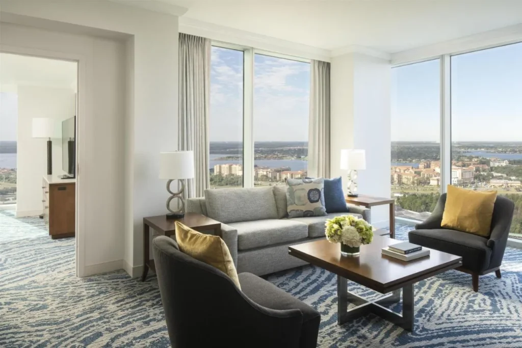 Suite living room with corner windows and lake views at Hyatt Regency Orlando