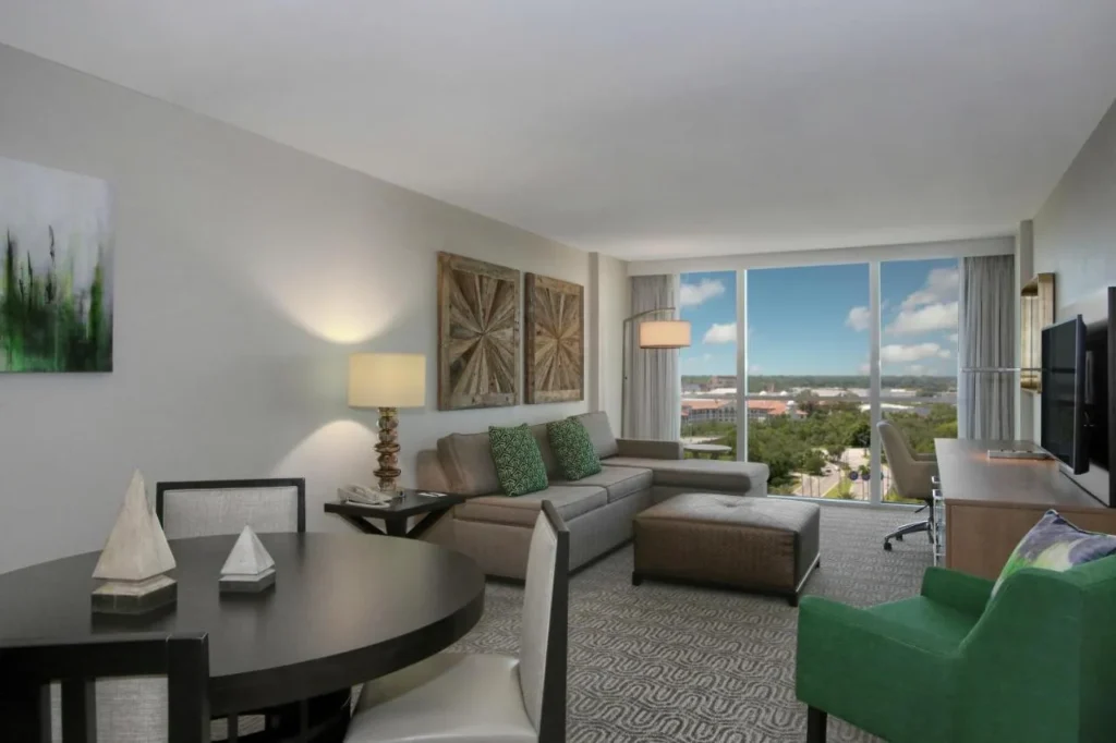 Suite living room with sectional sofa and tall windows, DoubleTree at the Entrance to Universal