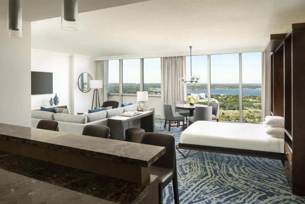 Suite with a fold-down wall bed, sectional sofa and wet bar at Hyatt Regency Orlando