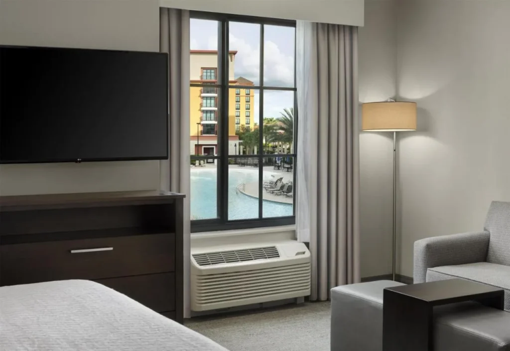 Suite with a window looking onto the pool at Homewood Suites by Hilton Flamingo Crossings