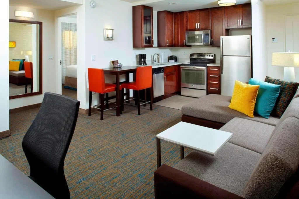 Suite with full kitchen, breakfast bar and sofa at Residence Inn Orlando Lake Nona