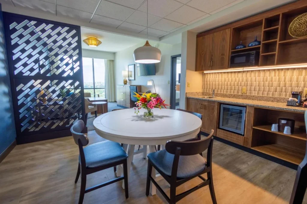 Suite with round dining table, wet bar, microwave and glass-door fridge at Drury Plaza Hotel Orlando