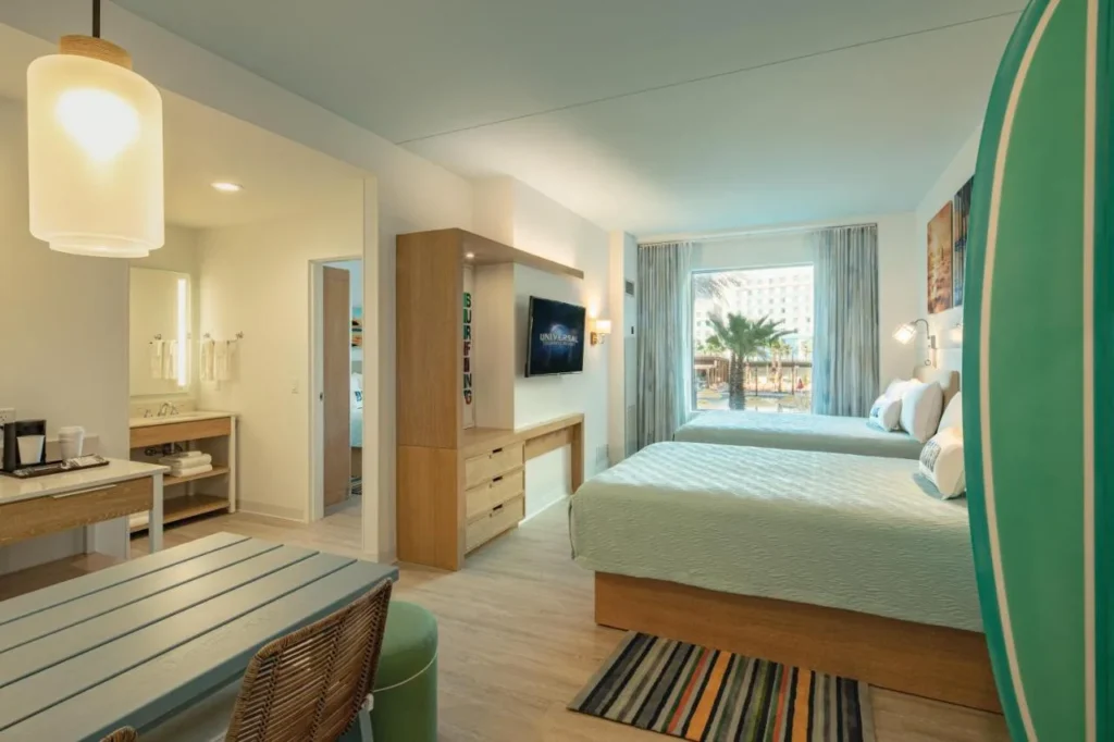 Suite with two queen beds, a picnic-style table and kitchenette at Endless Summer Resort Dockside