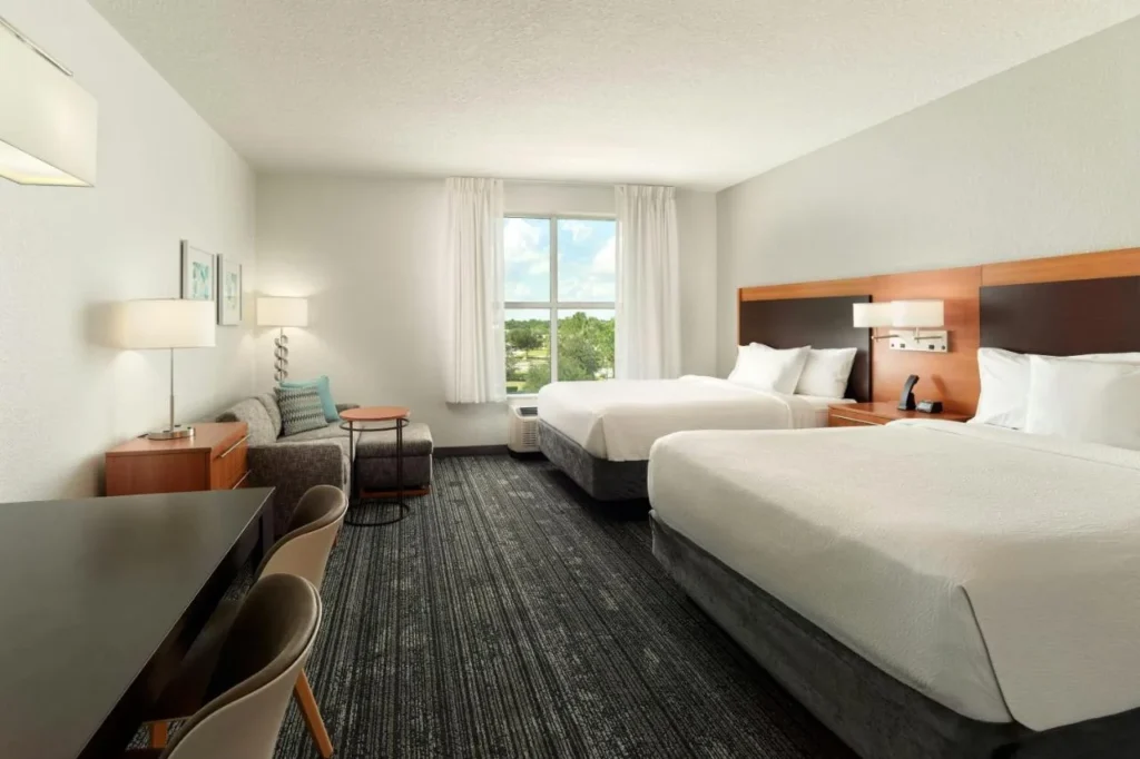 Suite with two queen beds, sofa and dining table, TownePlace Suites Flamingo Crossings