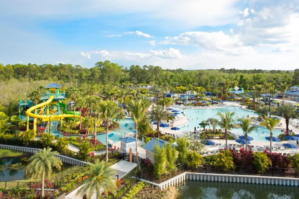 Surfari Water Park at The Grove Resort with yellow slides, lazy river and palm-lined pools