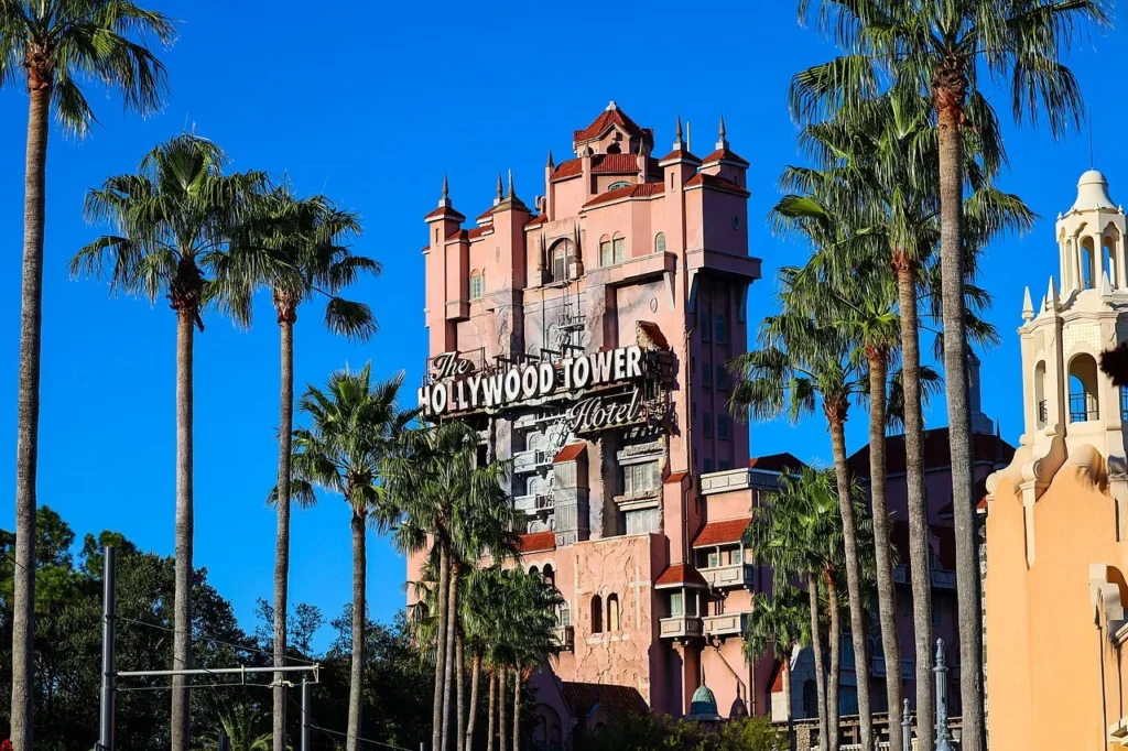The Hollywood Tower Hotel of Tower of Terror rising behind palm trees