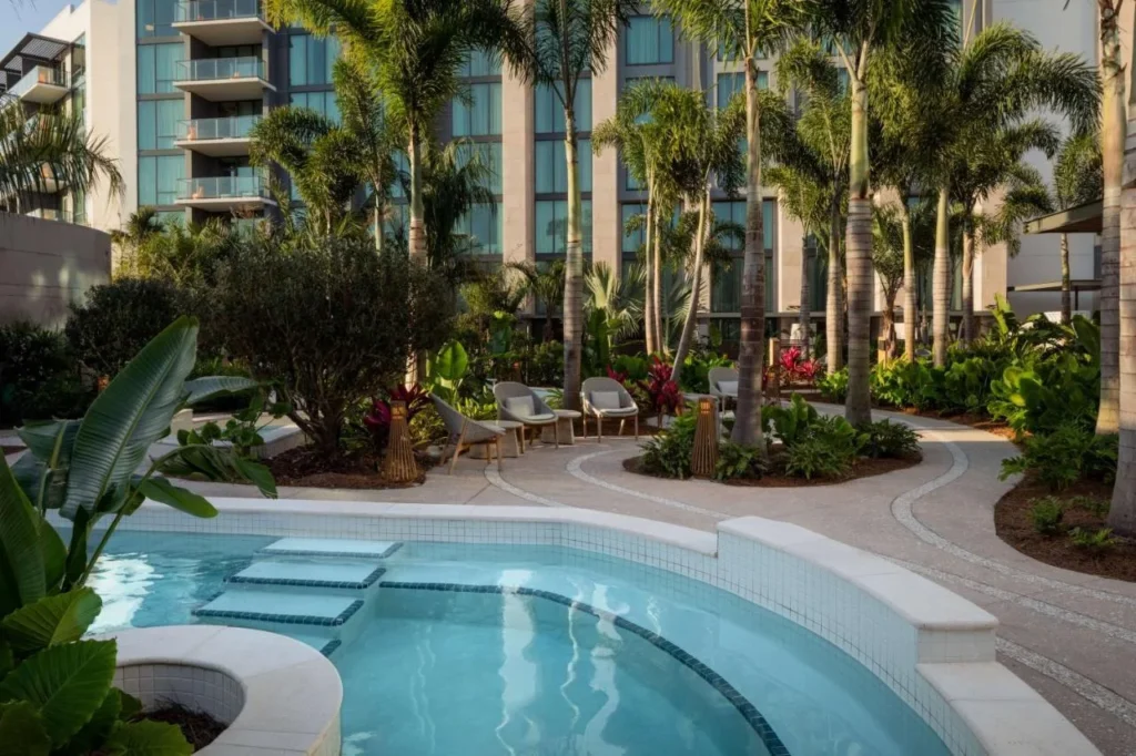 Tiled soaking pool in a palm garden below the Conrad Orlando guest tower