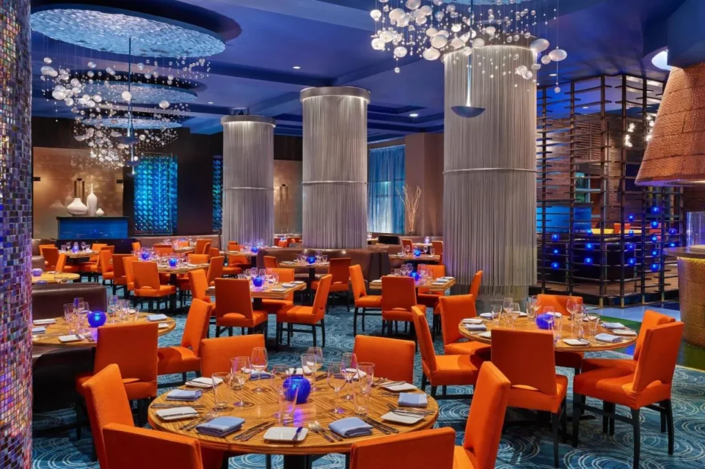 Todd English's bluezoo dining room with orange chairs and bubble chandeliers at Walt Disney World Dolphin