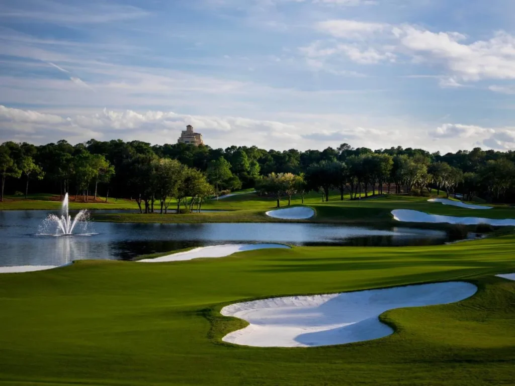 Tranquilo Golf Course bunkers and fountain pond with the Four Seasons Resort Orlando tower beyond