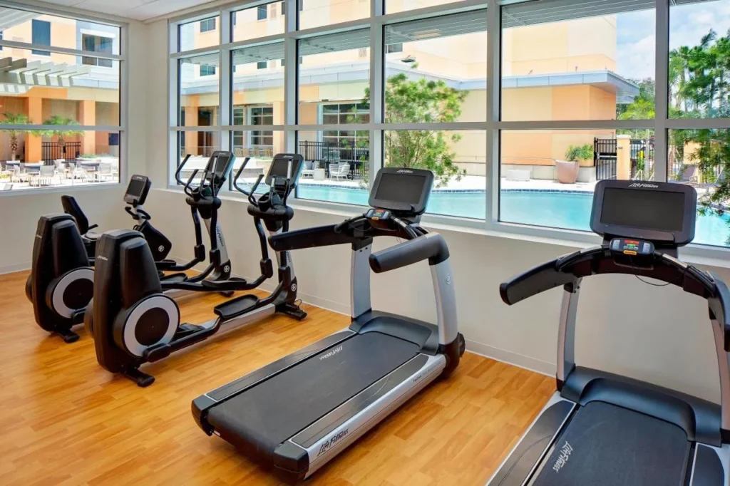 Treadmills and cardio machines overlooking the pool in the Hyatt House across from Universal gym