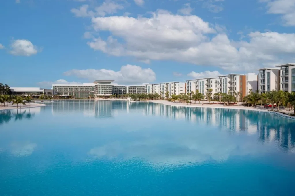 Turquoise Evermore Bay lagoon framed by white beachfront buildings at Evermore Orlando Resort