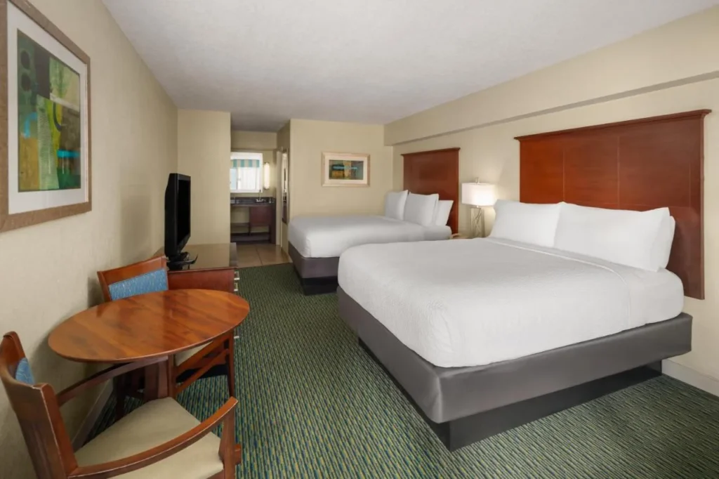 Two-bed guest room with a round table at Holiday Inn Resort Orlando Lake Buena Vista