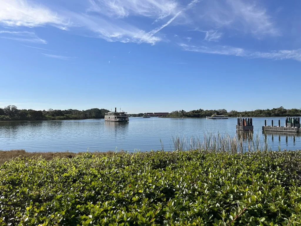 Two Magic Kingdom ferryboats and a water launch crossing Seven Seas Lagoon
