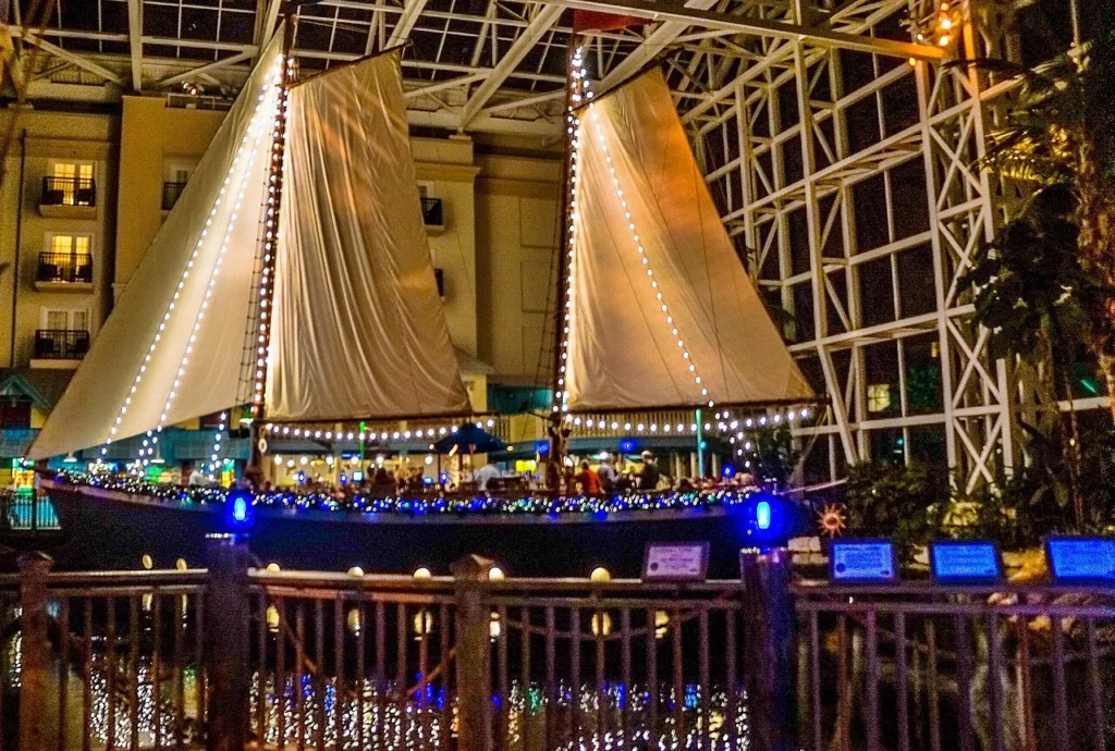 Two-masted sailing ship strung with white lights inside the Gaylord Palms atrium at night
