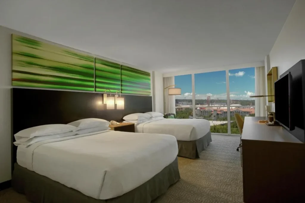 Two queen beds and floor-to-ceiling windows facing Universal at DoubleTree at the Entrance to Universal