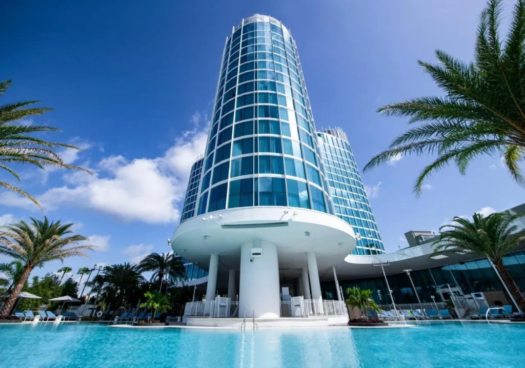 Universal Aventura Hotel glass tower rising above the resort pool and palm trees