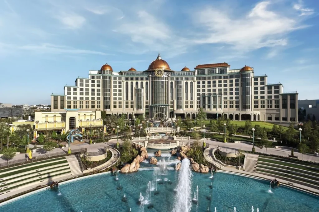Universal Helios Grand Hotel's copper-domed facade above a fountain pool and terraced gardens
