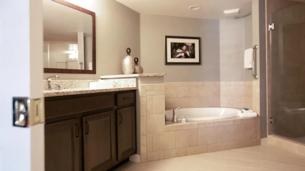 Villa bathroom with a corner tub, granite vanity and glass shower at Orange Lake Resort
