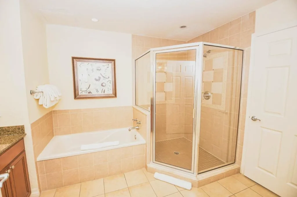 Villa bathroom with a soaking tub and glass-enclosed shower at Reunion Resort & Golf Club