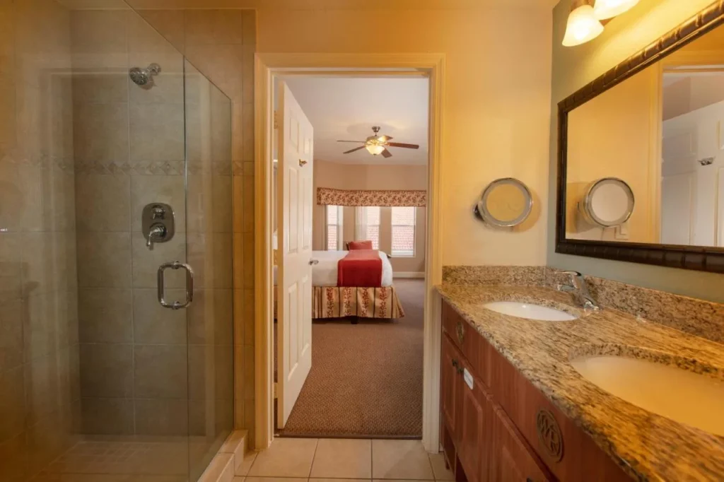 Villa bathroom with glass walk-in shower and double granite vanity at Westgate Town Center Resort