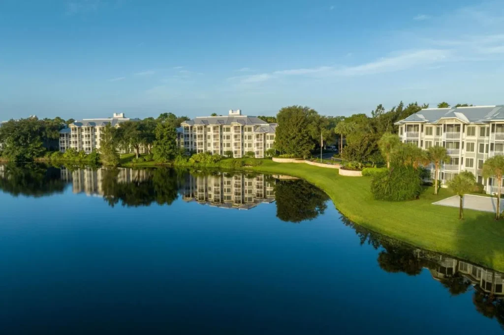 Villa buildings reflected in the lake on a clear morning at Marriott's Cypress Harbour