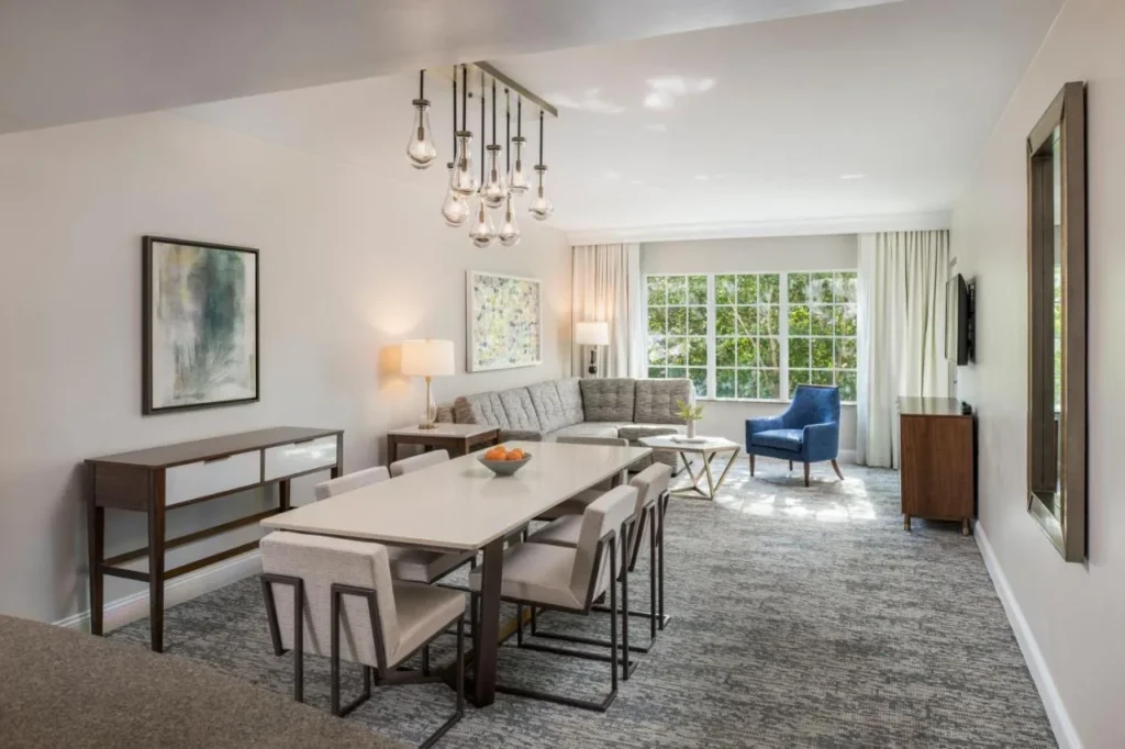 Villa dining table and living room with large windows at Marriott's Lakeshore Reserve