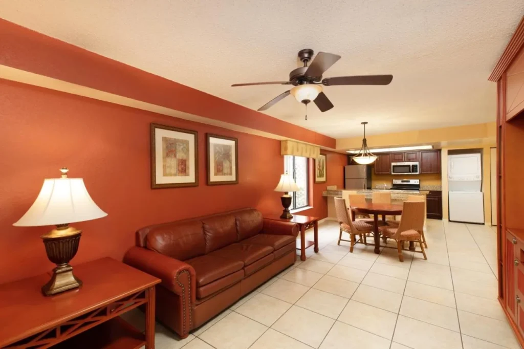Villa living room with leather sofa, dining table, kitchen and stacked washer-dryer at Westgate Vacation Villas