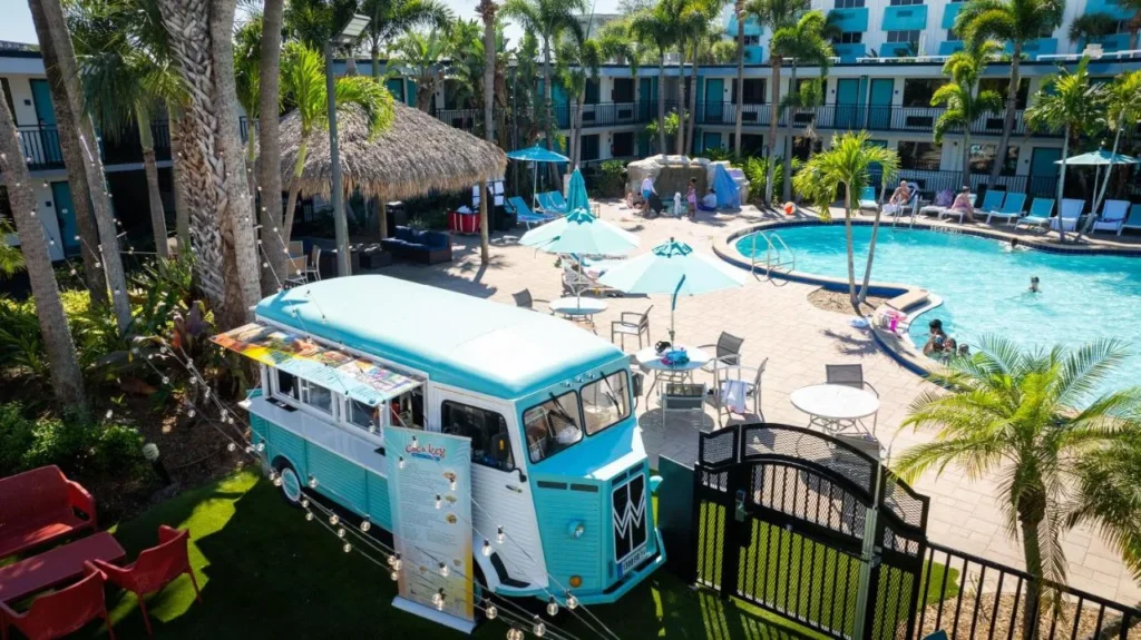 Vintage food truck beside the palm-lined resort pool at CoCo Key Hotel and Water Resort