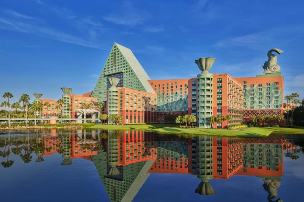 Walt Disney World Dolphin pyramid tower and dolphin statue reflected in a calm lake