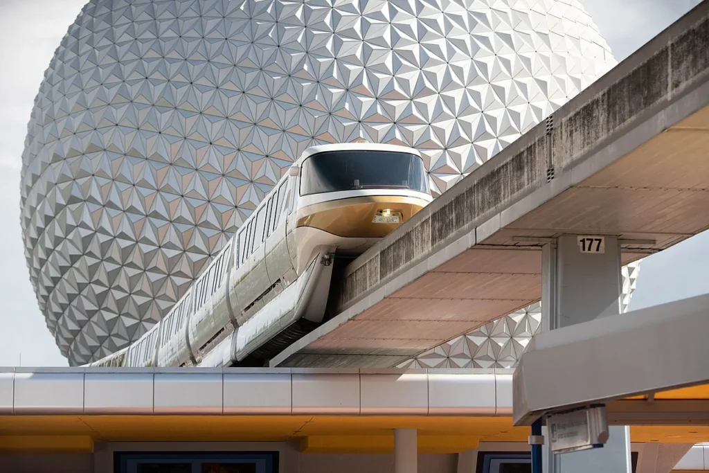 Walt Disney World monorail gliding past the faceted silver sphere of Spaceship Earth at EPCOT